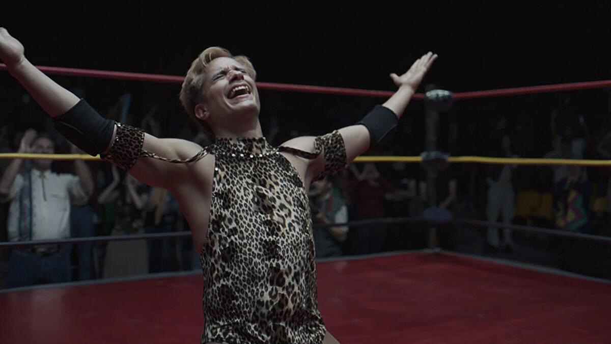 Gael García Bernal in an animal-patterned wrestling costume celebrates in the ring with arms outstretched in "Cassandro."