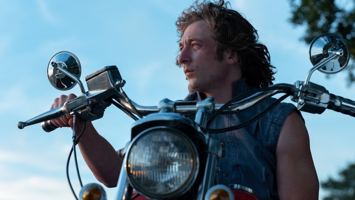 Jeremy Allen White with long hair on a motorcycle in The Iron Claw