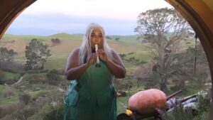 Lizzo as Lizzolas plays The Lord of the Rings theme concerning hobbits on recorder in a hobbit hole