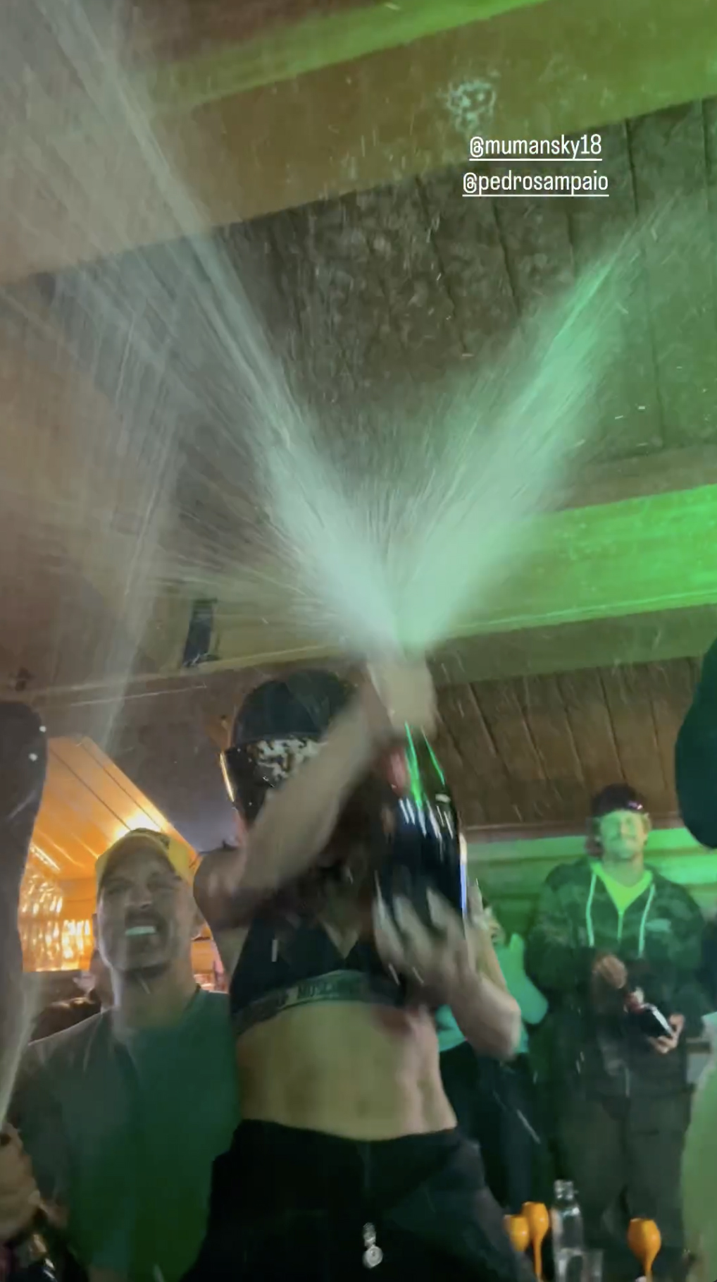 Anitta and Mauricio were spraying bottles of champagne at the party