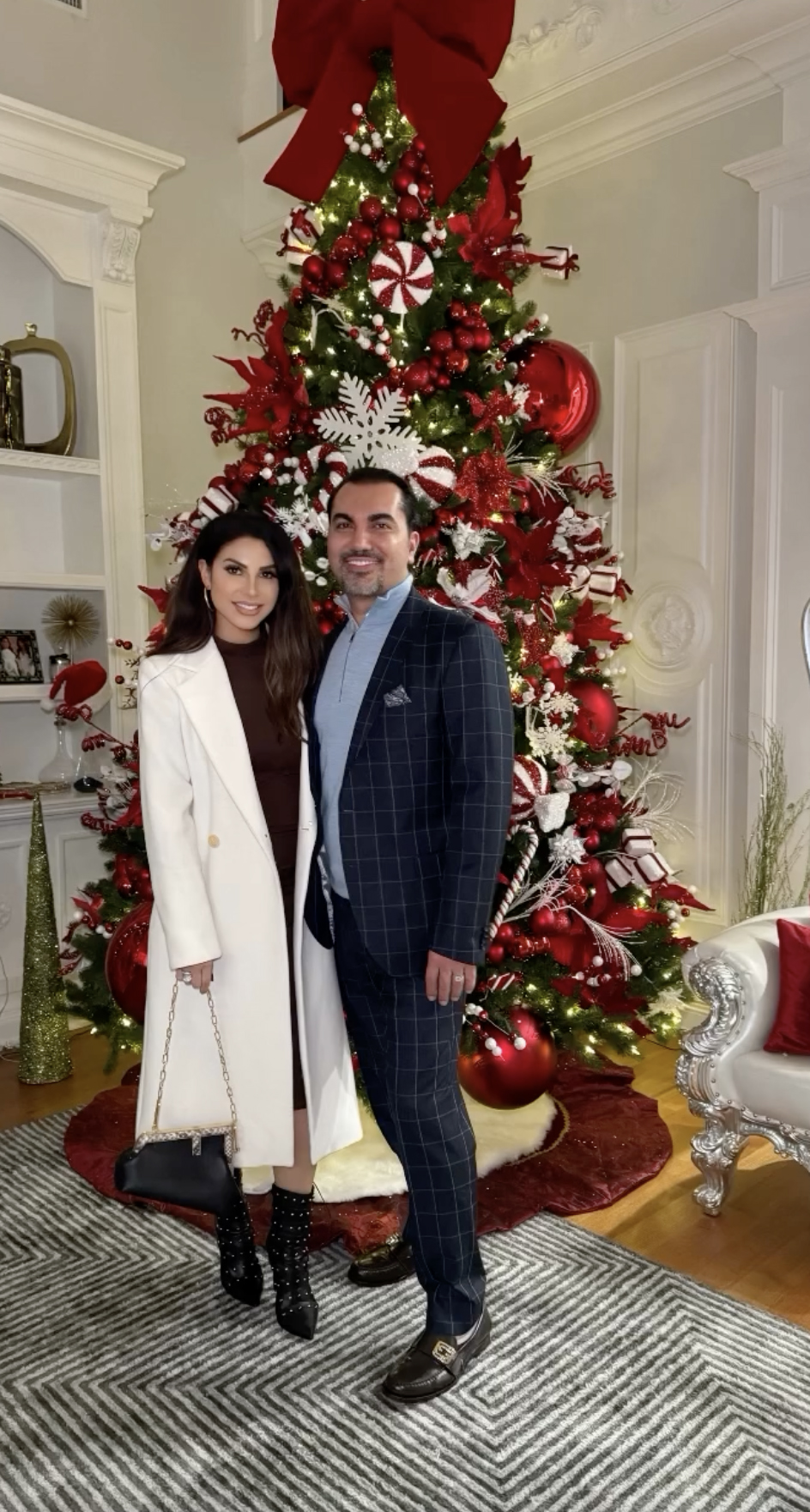 Jennifer and her husband Bill Aydin posed in front of their red and white Christmas tree