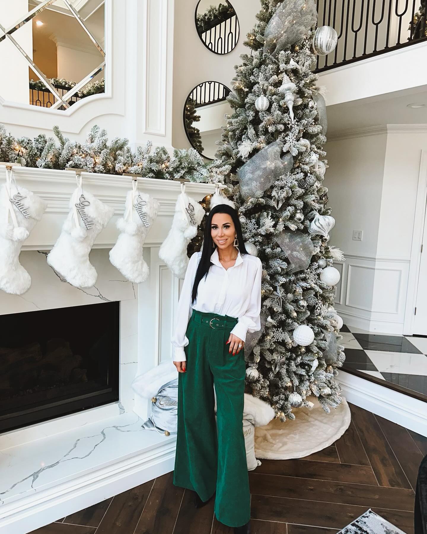 Rachel posed in front of her fireplace inside her over-one-million-dollar mansion