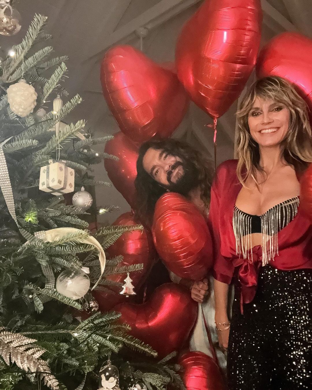 Heidi posed with her husband Tom Kaulitz by the Christmas tree