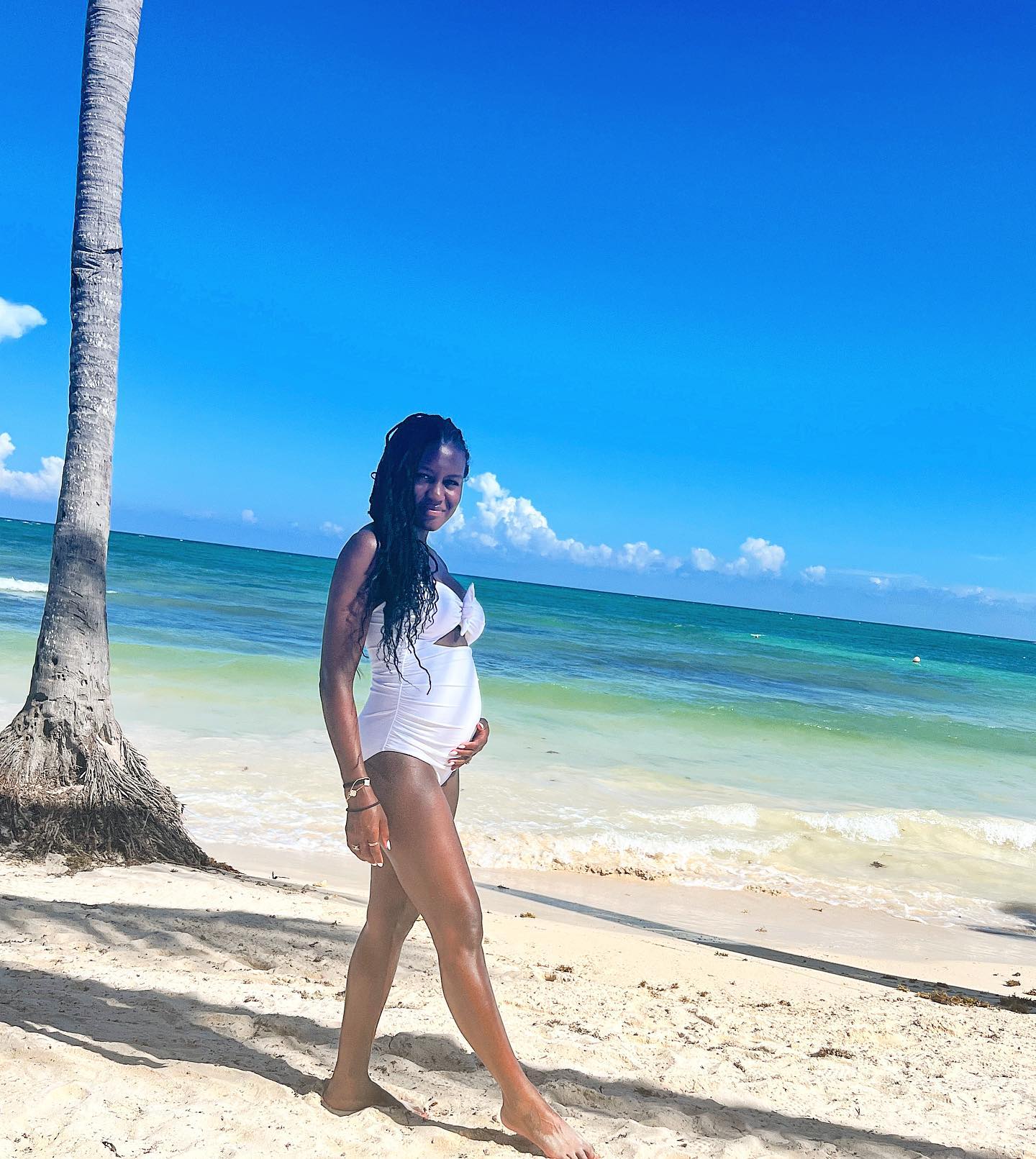 She showed off her developing baby bump while on vacation over the summer