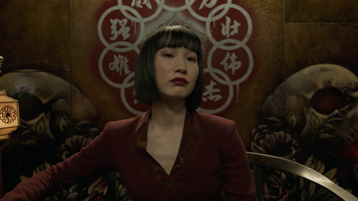 Xialing sits on her throne as the new leader of the Ten Rings at the end of Shang-Chi