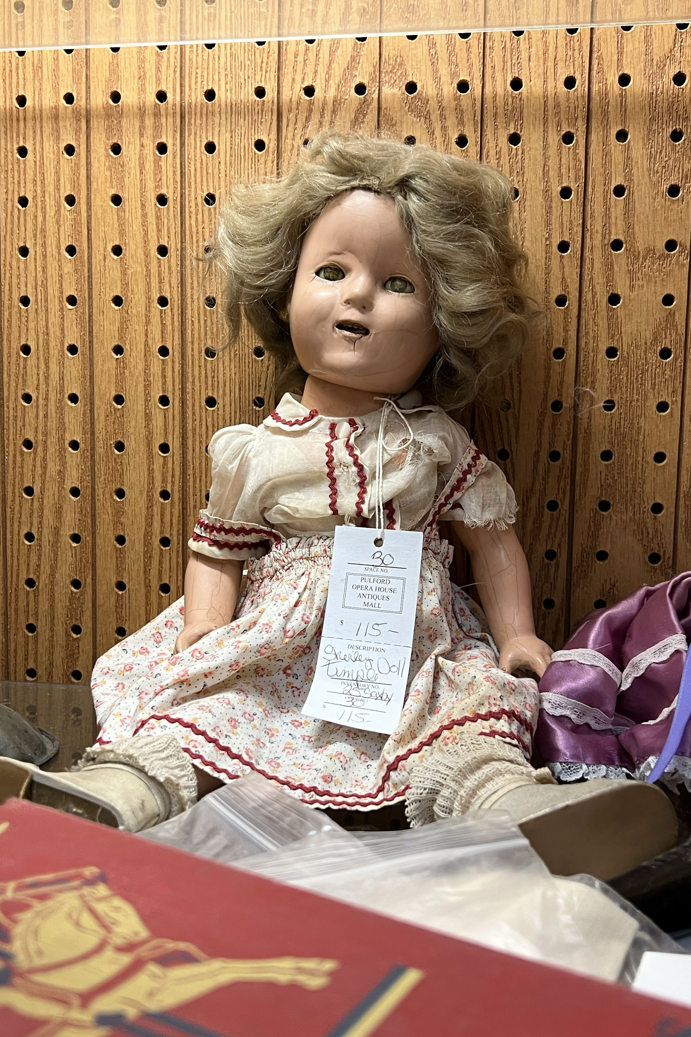 A doll with cracks on the face and arms goes for $115