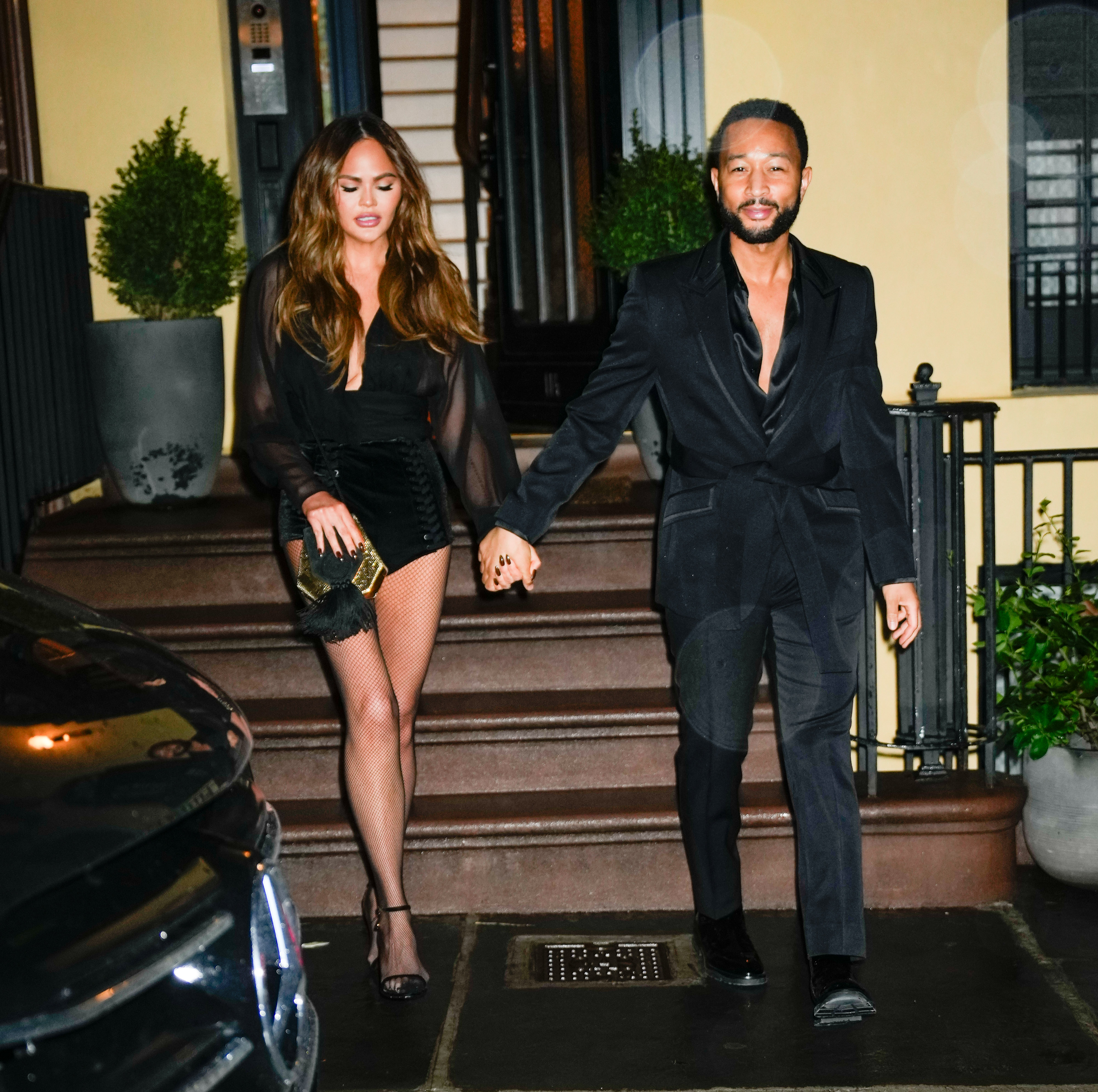 Chrissy showed off her long, model legs in a pair of netted tights and black velvet bottoms as she and John exited the restaurant