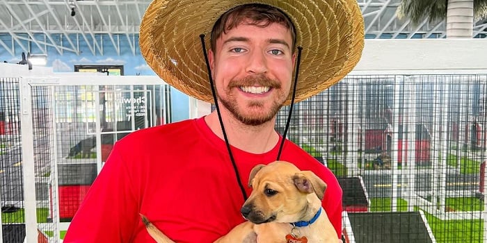Mr Beast posing for a camera with his dog