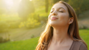 woman breathing fresh air in sunshine
