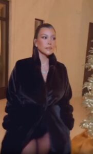 Kourtney Kardashian showed off her incredible post-baby curves in a black catsuit at her family's annual Christmas Eve party