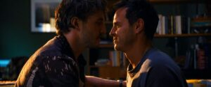 Paul Mescal and Andrew Scott sit close looking at each other in a scene from "All of Us Strangers."