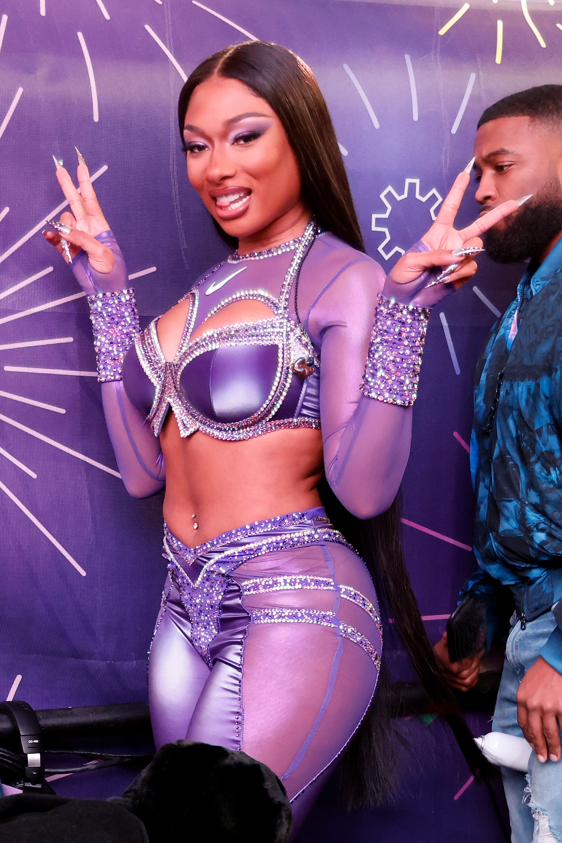 Megan Thee Stallion stunned in this sequin bralette and matching rhinestone-encrusted trousers for her New Year’s Eve show