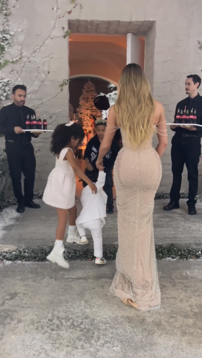 Khloe was filmed with True and Tatum at the family's Christmas Eve party, but fans fixated on the two men holding trays of Coca-Cola in the background