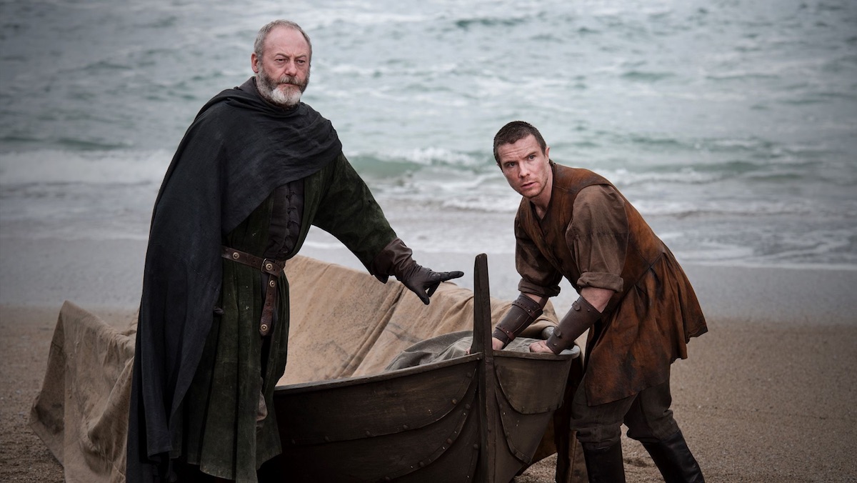 Davos and Gendry getting back into a row boat near the shore on Game of Thrones