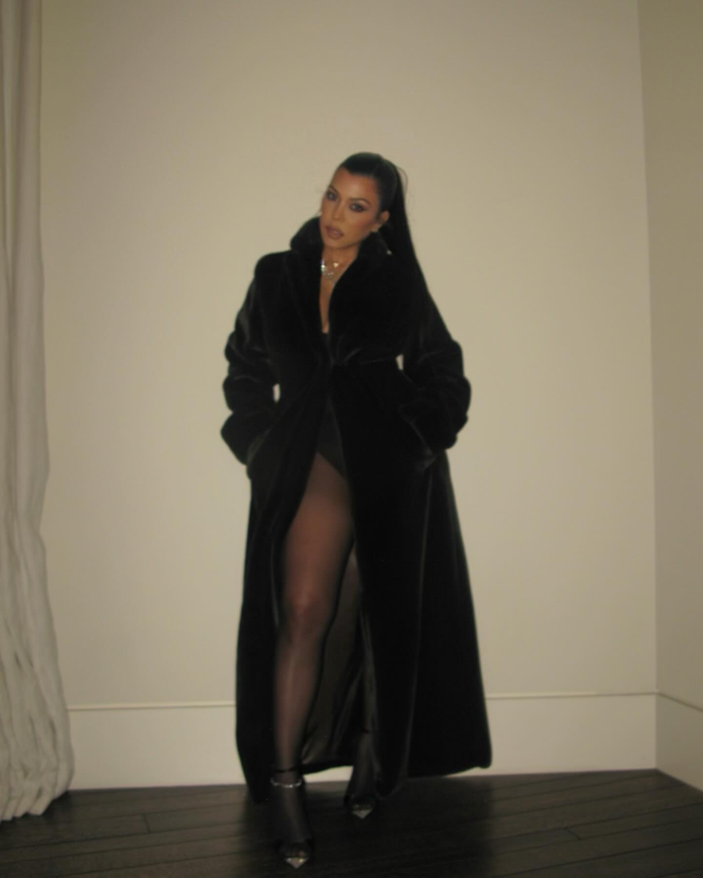 Kourtney flaunted her post-baby body while posing for a series of sultry snaps that showcased her head-turning outfit for the Kardashian Christmas Eve Party