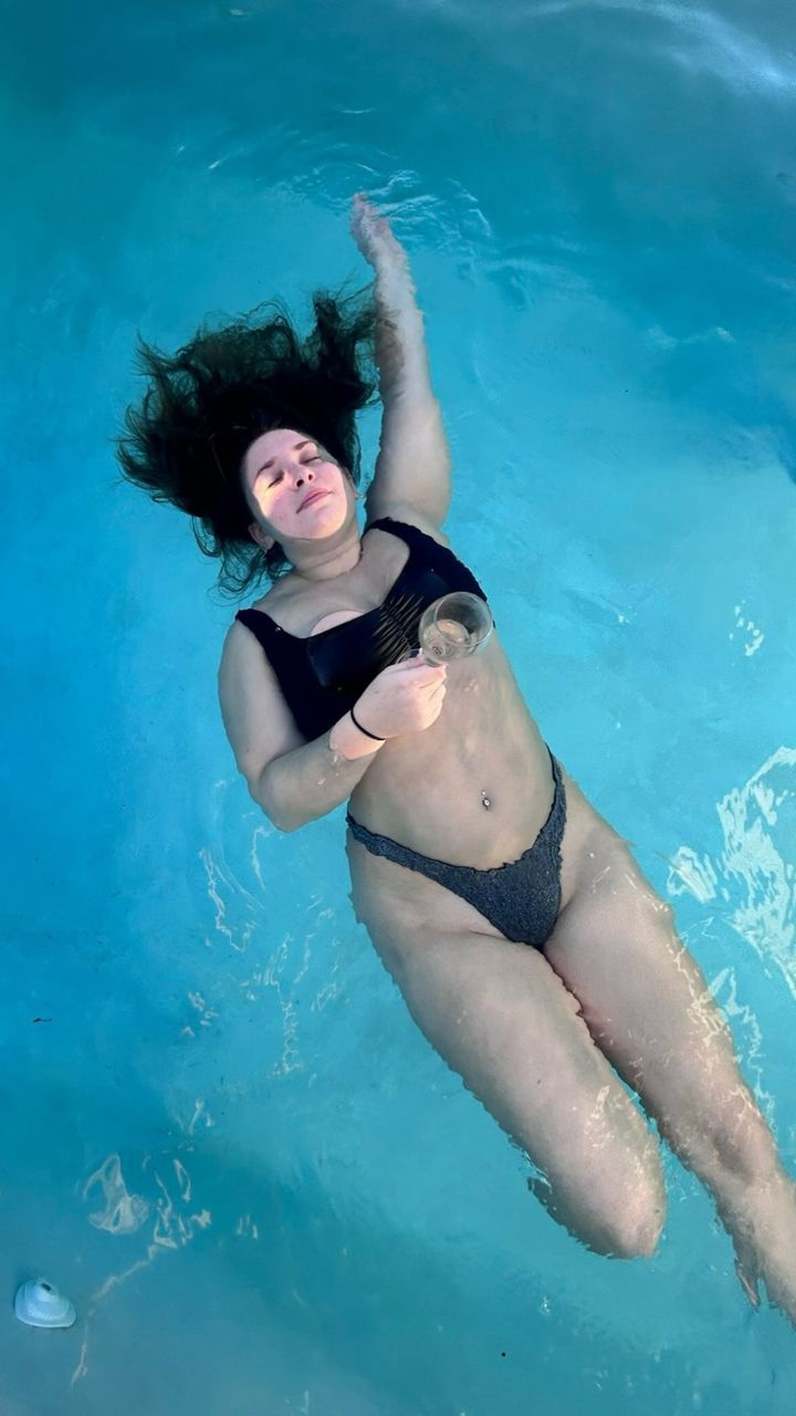 The 21-year-old showed off her curves in a black bikini as she soaked in a pool at her resort