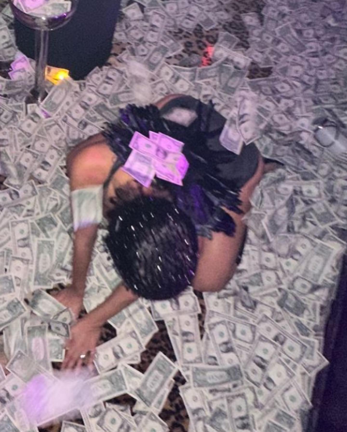 Kanye West's wife was captured rolling in dollar bills during a visit to a strip club