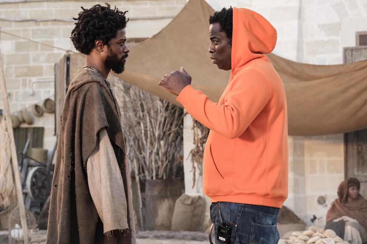 Two men collaborate on the set of a Biblical drama.
