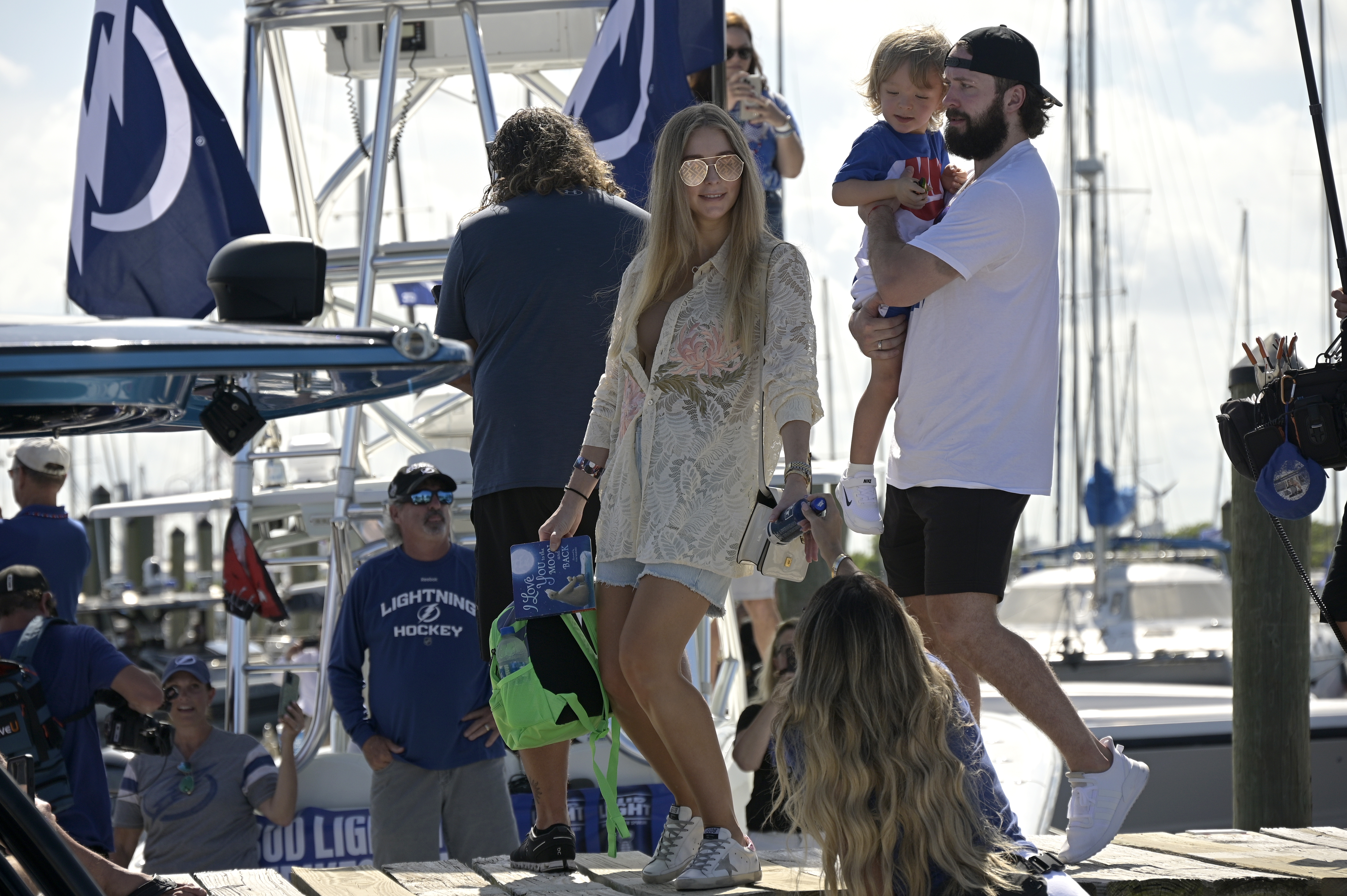 Nikita carries his son Max while walking with his wife Anastasiya before the NHL hockey Stanley Cup champions' Boat Parade, Monday, July 12, 2021, in Tampa, Florida