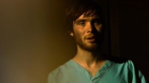 Cillian Murphy with a beard in hospital pajamas in 28 Days Later