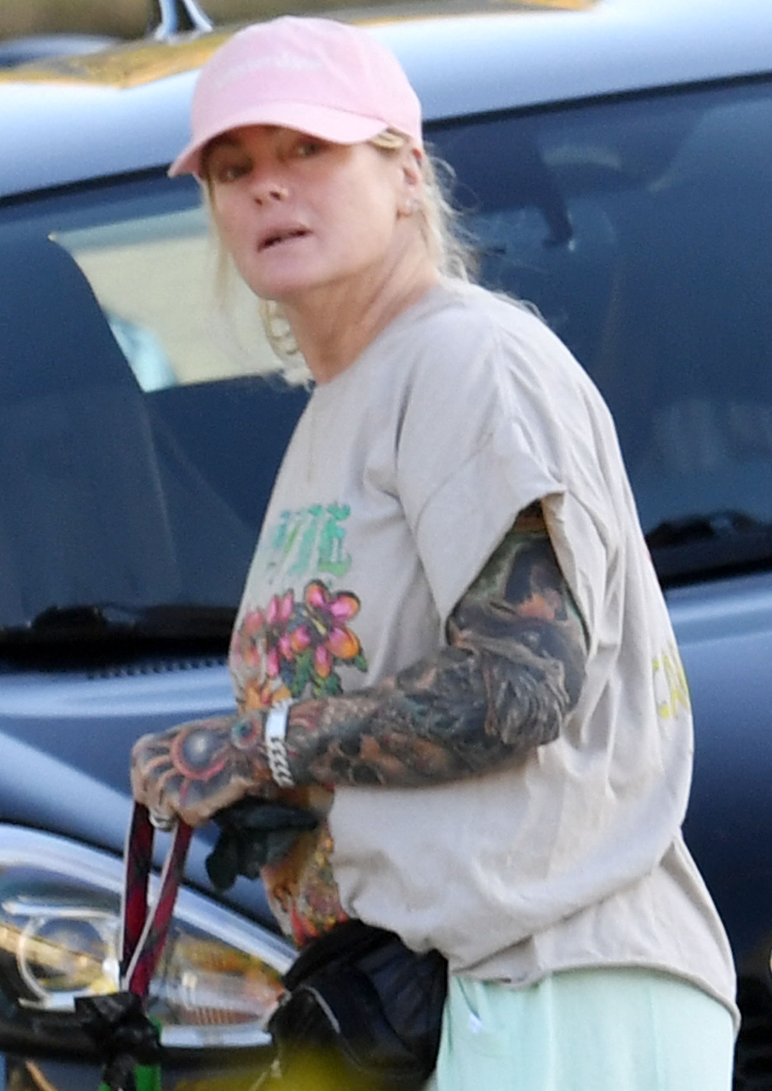 The 54-year-old looked totally different with huge tattoos and sweats