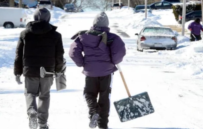 Robbie Wolfe shared a photo of two shovelers dealing with the snow-covered ground