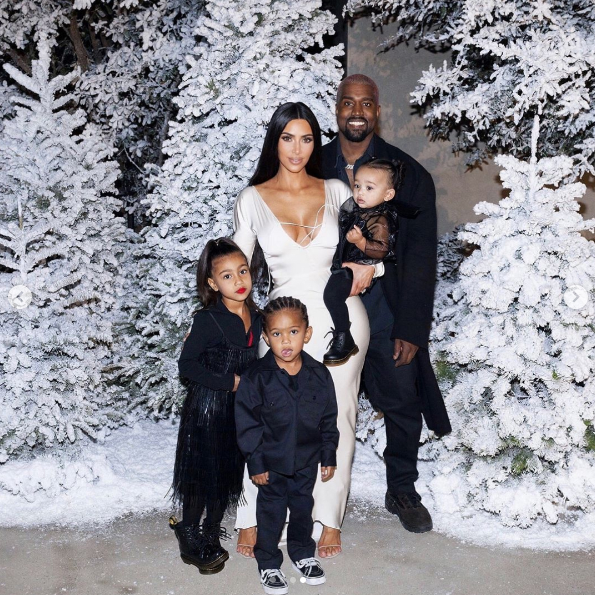 Kim and Kanye West pictured with their kids at an event in 2018