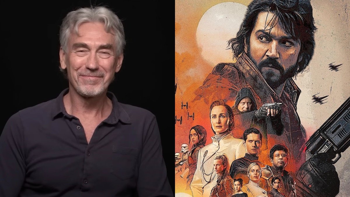 Tony Gilroy smiles sititng in front of a black background/Orange hued Andor poster featuring the show's main characters