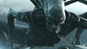 A Xenomorph crouched and ready to strike on the wing of a ship in Alien: Covenant