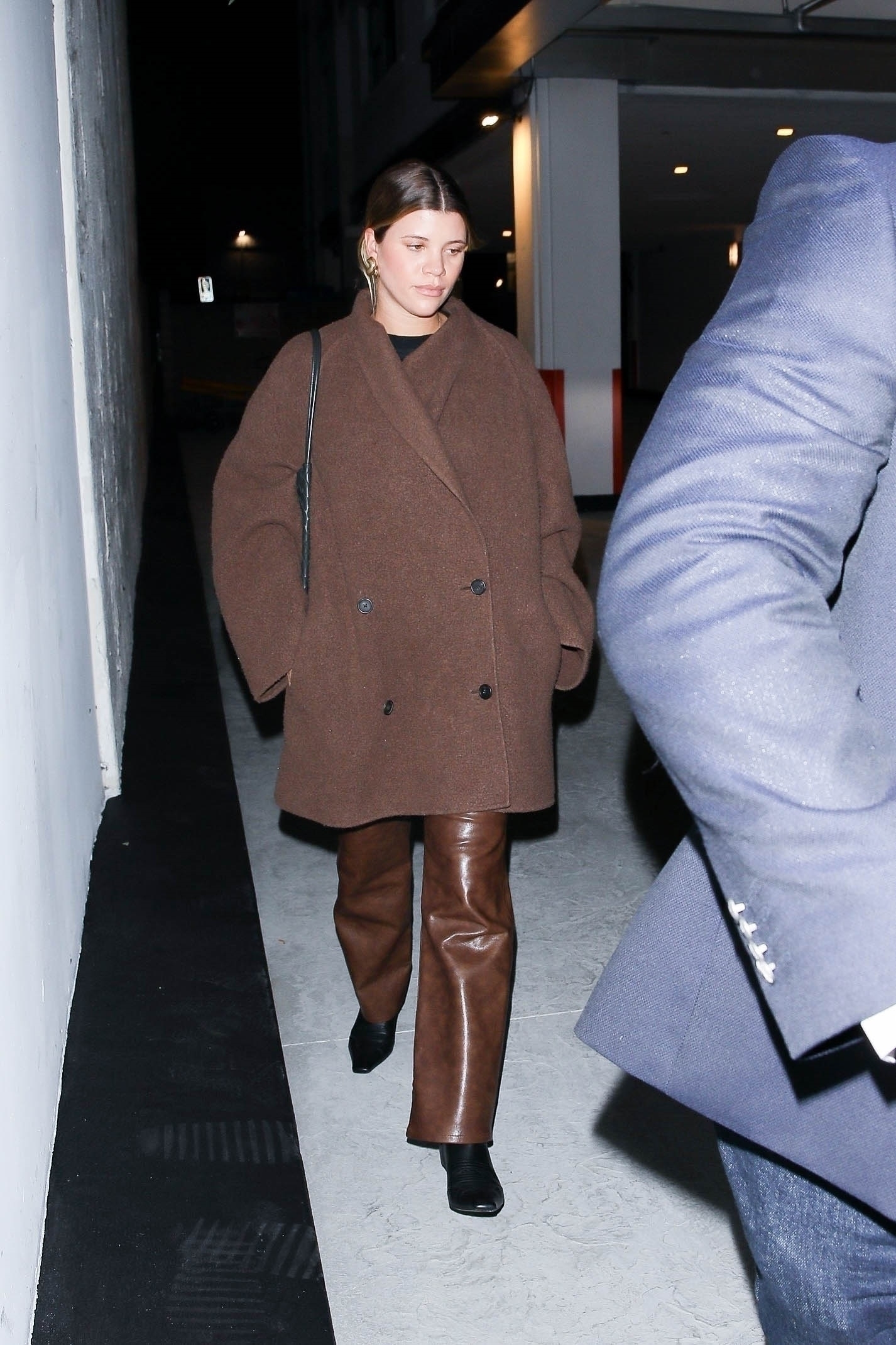 Sofia donned a giant, brown winter coat that covered her entire torso and nearly draped down past her knees