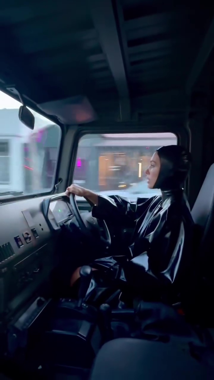 He filmed her driving a car while wearing a black latex cape and headpiece