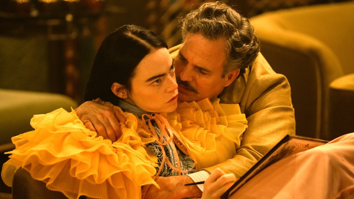 MArk Ruffalo and his mustache holds Emma Stone in a puffy dress in an image from Poor Things, Poor Things is a 2024 Oscar nominee