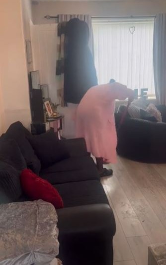 She filmed herself tidying her living room, which also serves as a bedroom