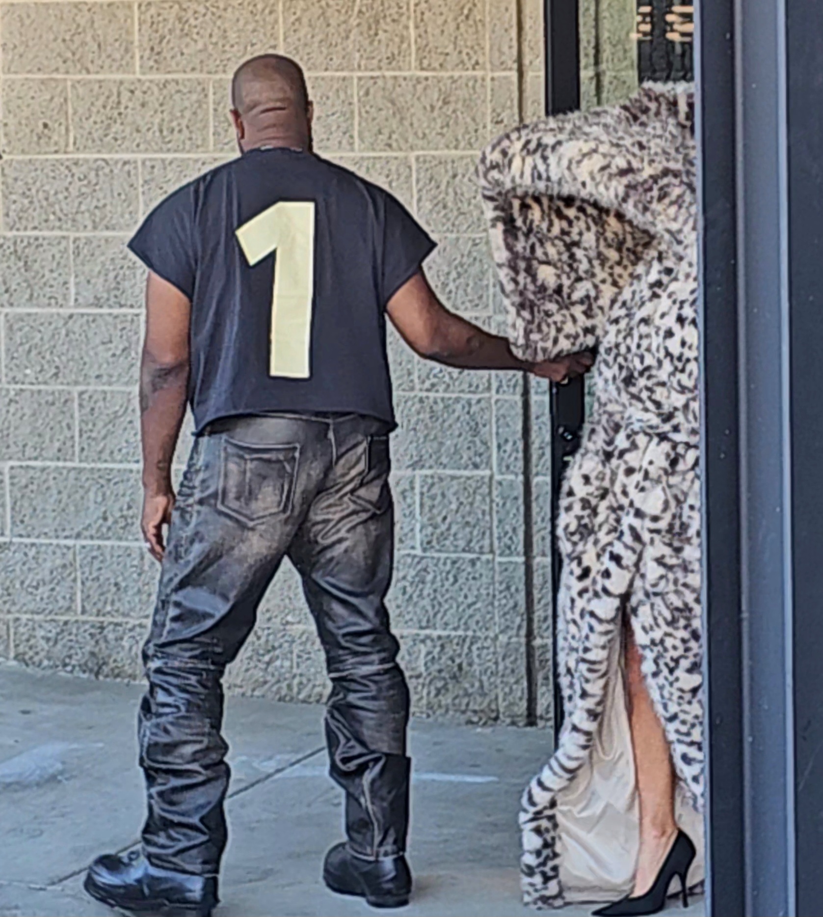 Kanye's outfit choice was more subtle, opting for a black tee and pants