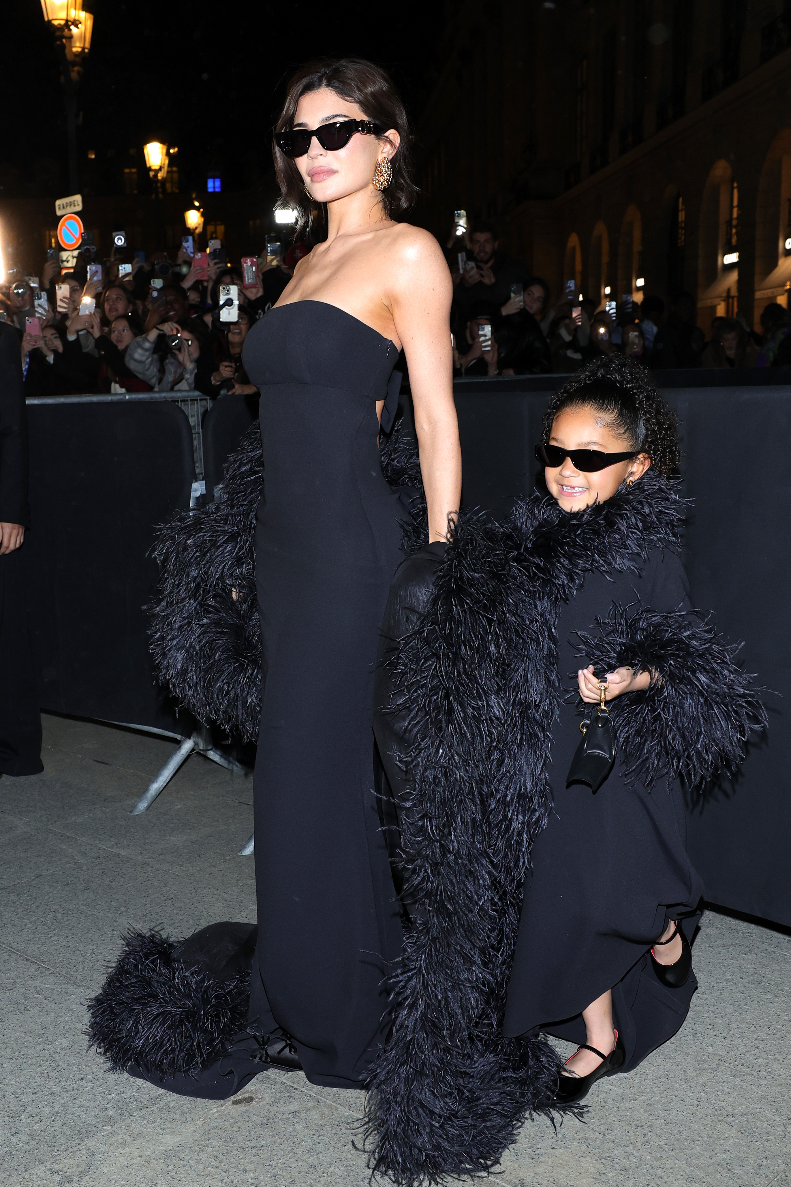 She also sported a black skintight strapless gown, matching her daughter Stormi