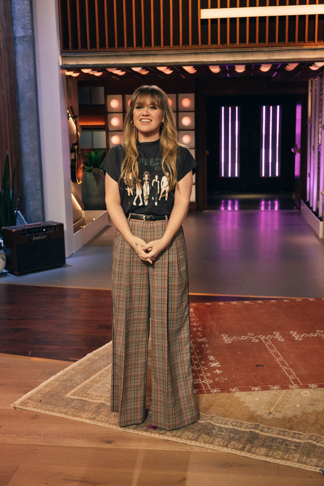 Kelly wore a Spice Girls T-shirt with baggy plaid pants.