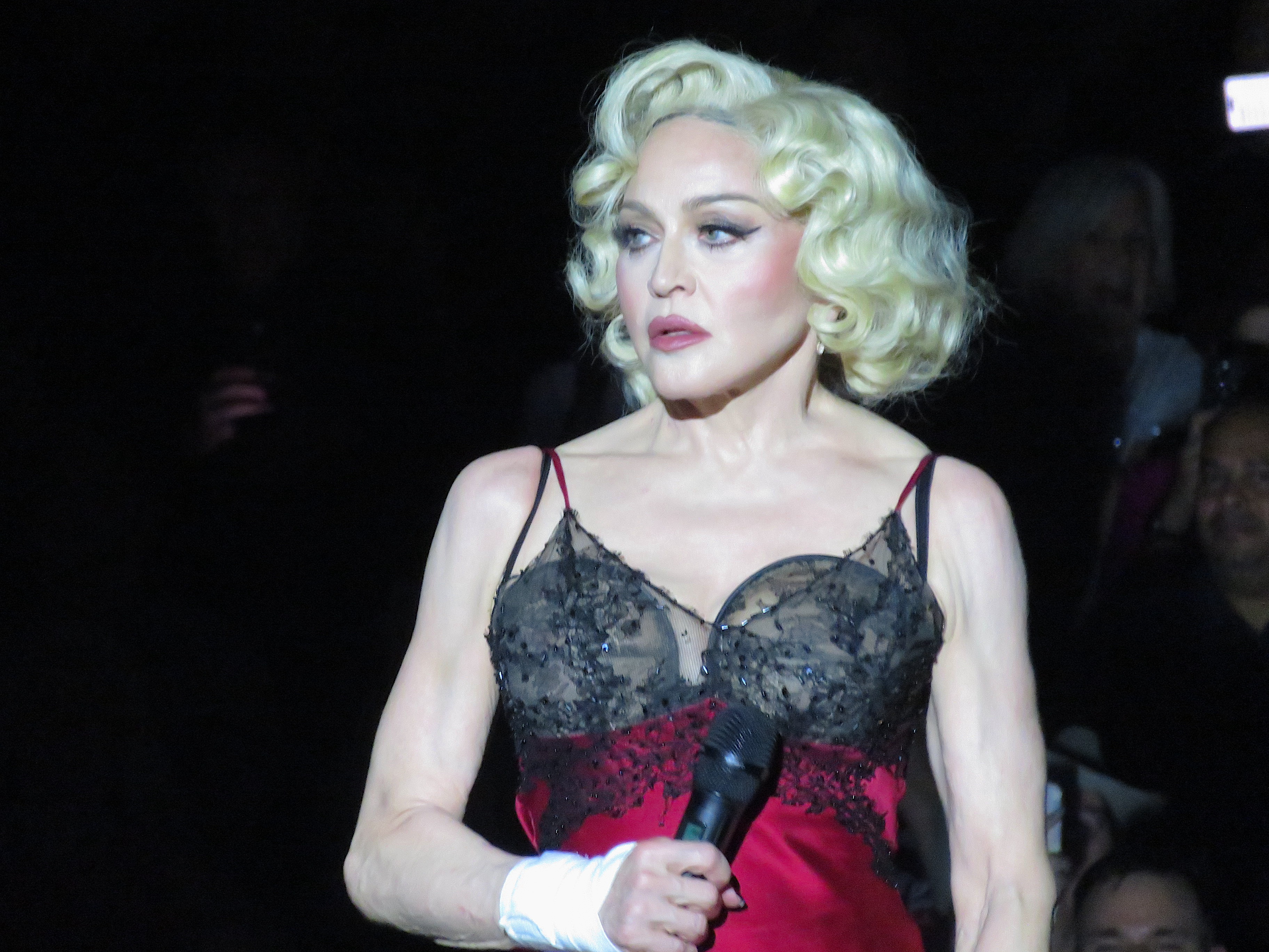 One of Madonna's close associates has pleaded with fans to go easy on her after she was reportedly late for gigs