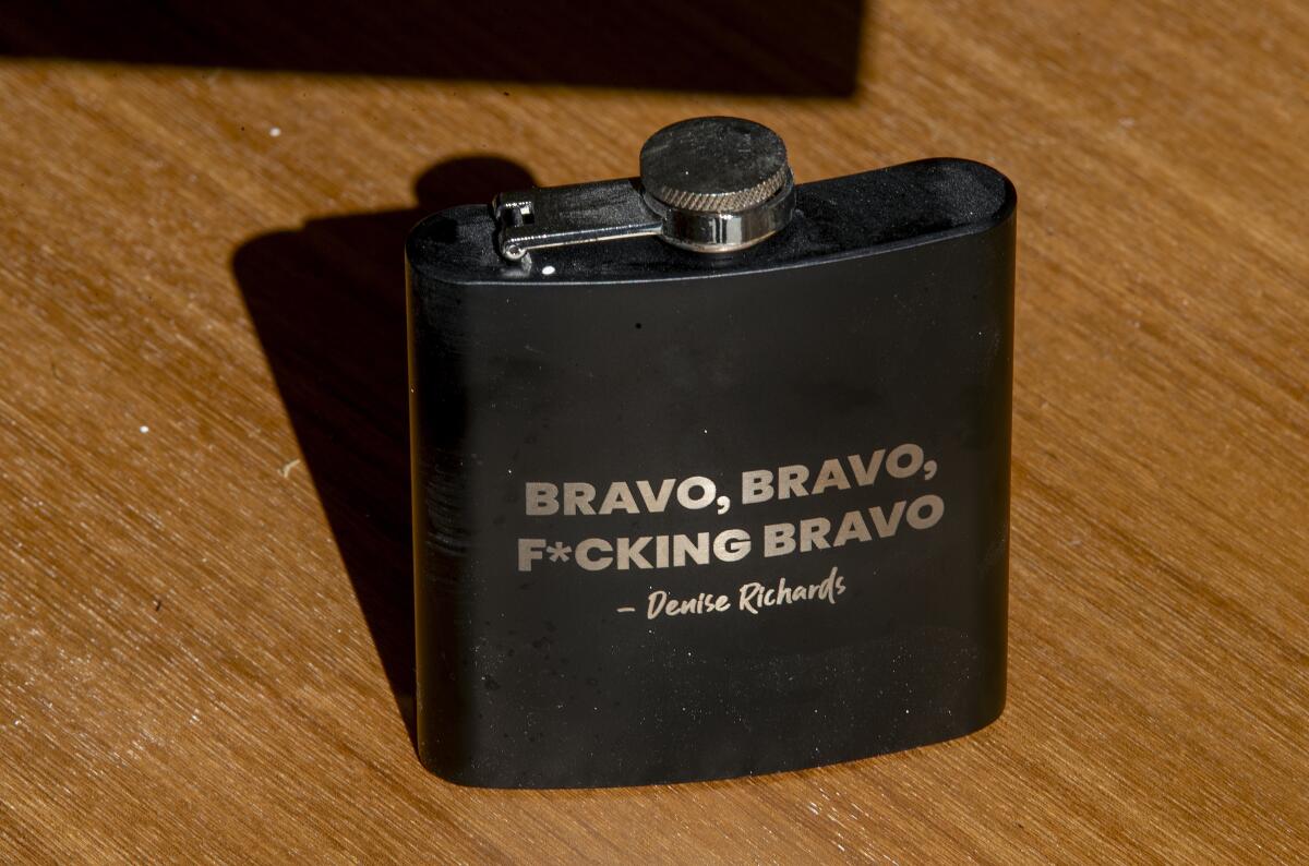 A black flask with Bravo, Bravo, F*cking Bravo, Denise Richards in golden letters.