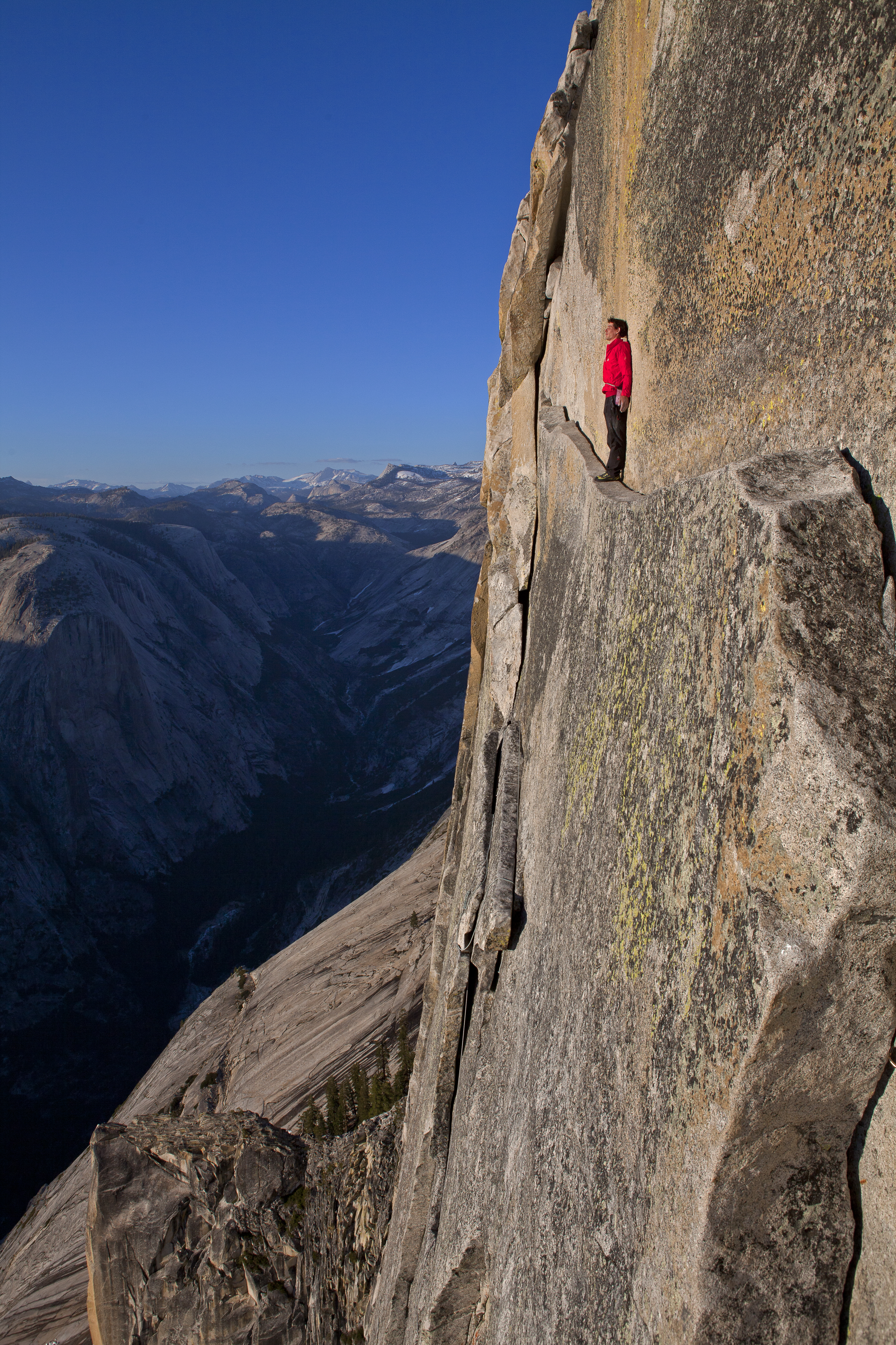 Alex stands on a precarious ledge on the Northwest Face of Half Dome, in 2018