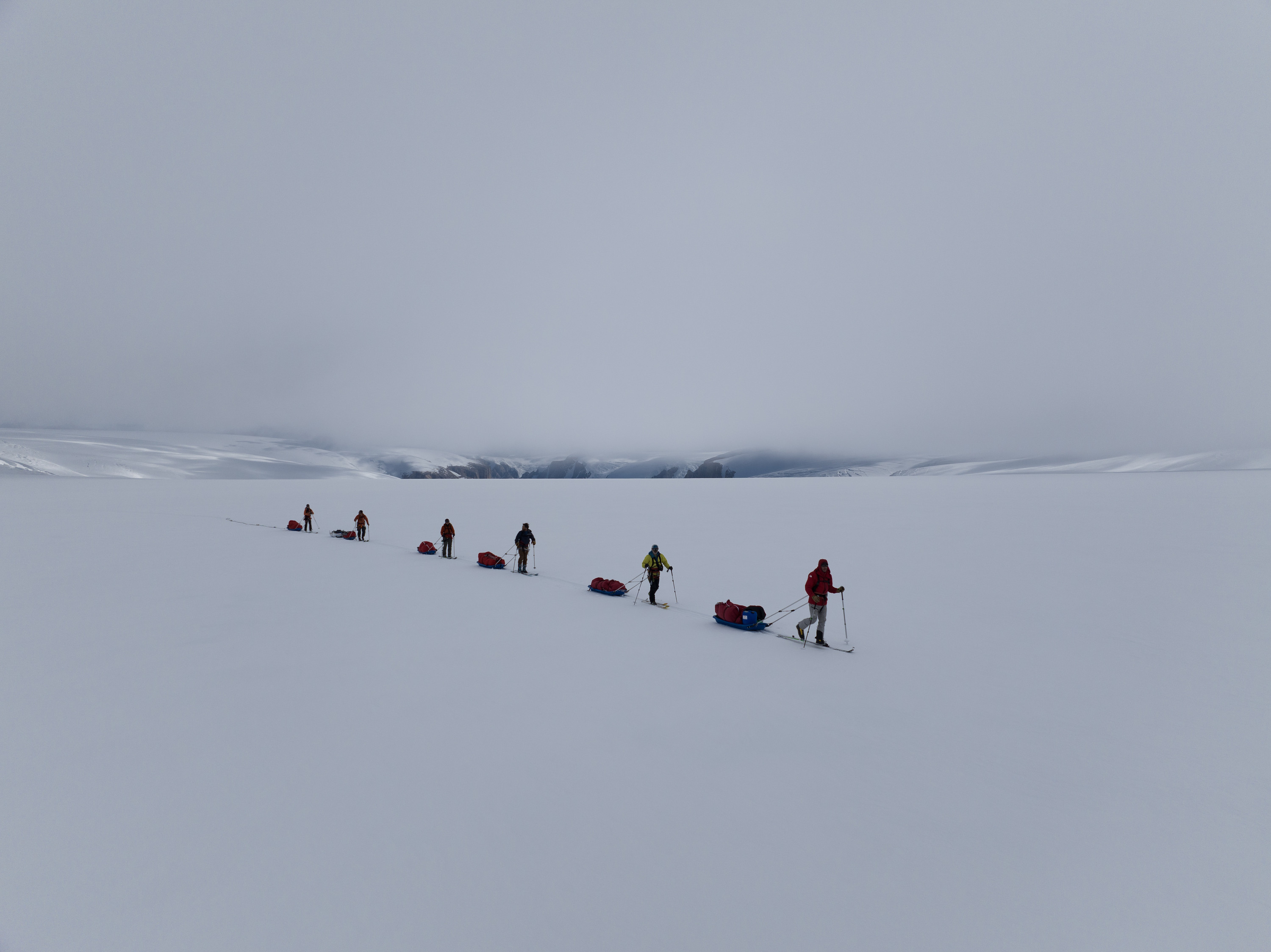 The team trek through the snow on the ice reservoir