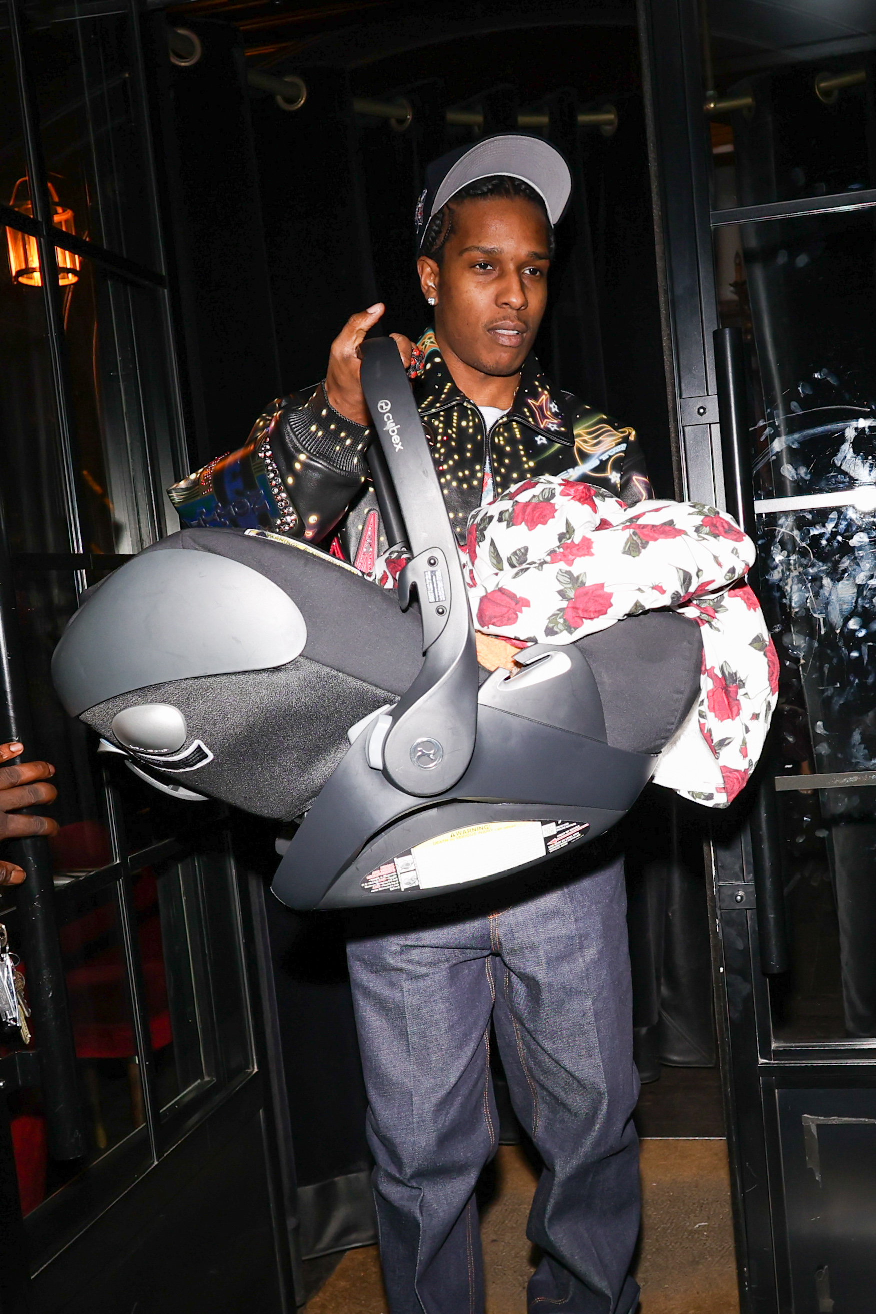 Hubby ASAP Rocky, holding baby Riot, joined Rihanna in Paris