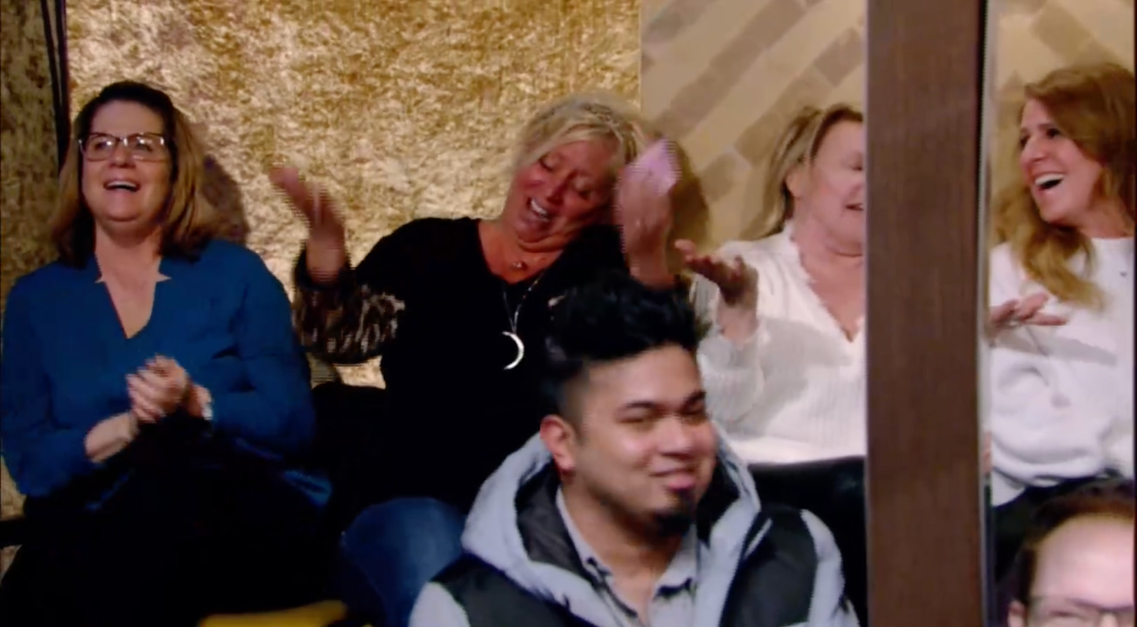 A woman who was the lucky winner was sitting behind a pole in the studio