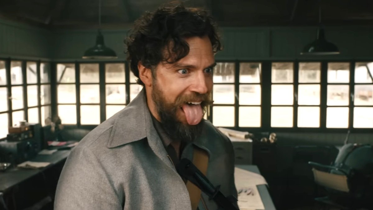 A bearded Henry Cavill sticks out his tongue like a madman in The Ministry Of Ungentlemanly Warfare