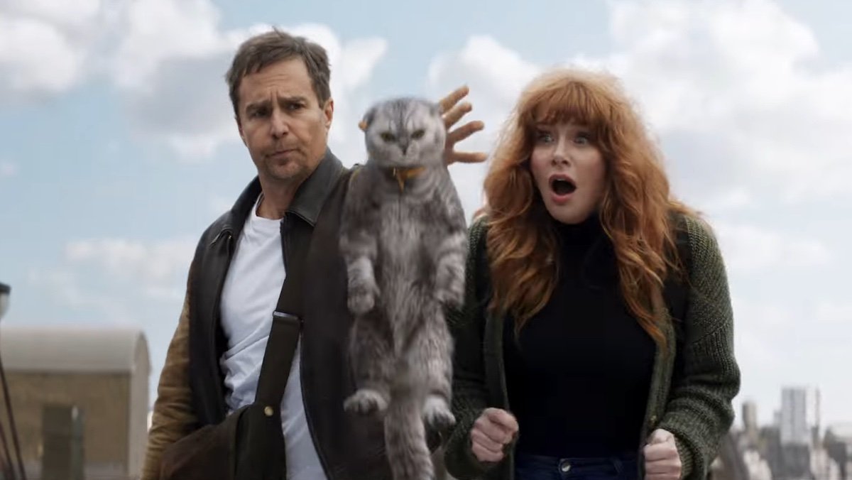 Sam Rockwell drops a cat off a roof while Bryce Dallas Howard looks on in shock in Argylle