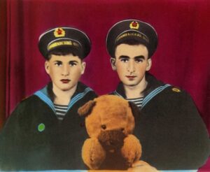Two young military personnel with a teddy bear