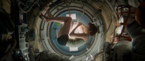 Sandra Bullock floating in the spaceship capsule in Gravity.