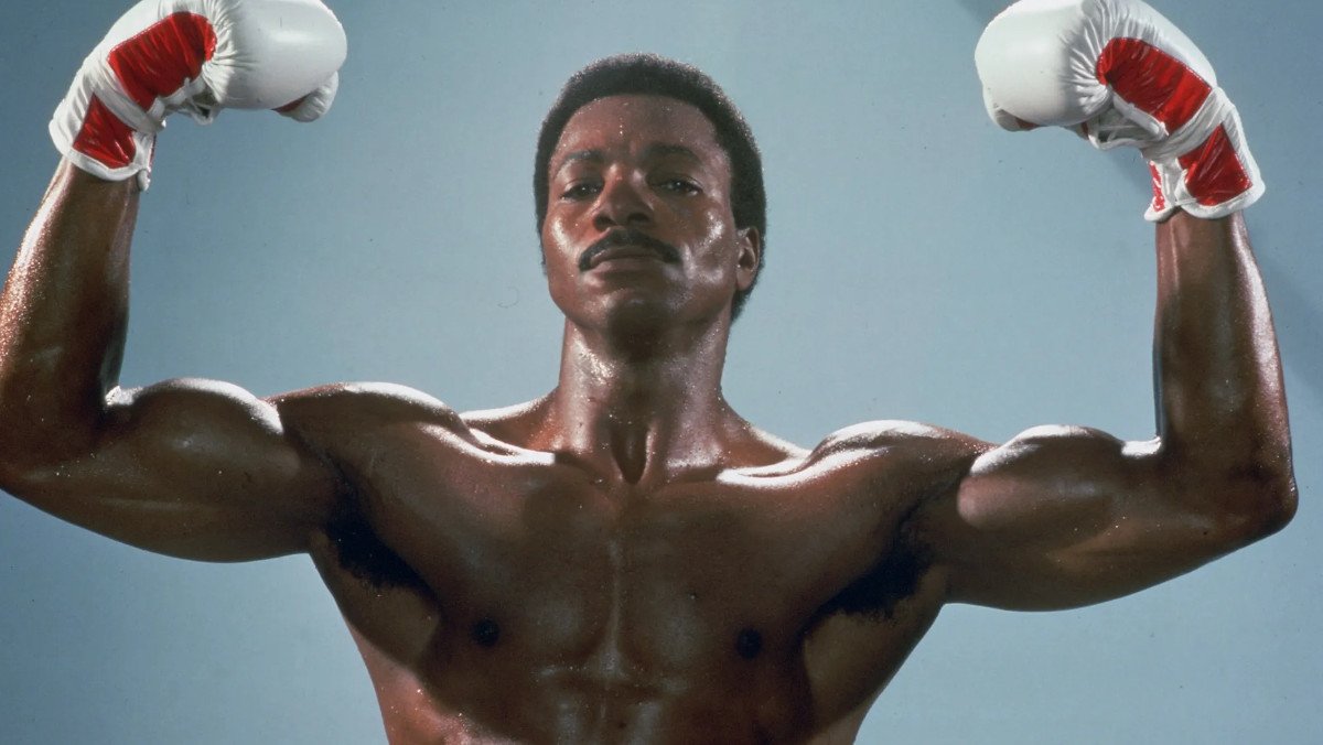 Apollo Creed flexing in Rocky IV, played by Carl Weathers, who has passed away at age 76