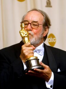 Cinematographer Russell Boyd kisses his Oscar after winning for "Master and Commander: The Far Side of the World"