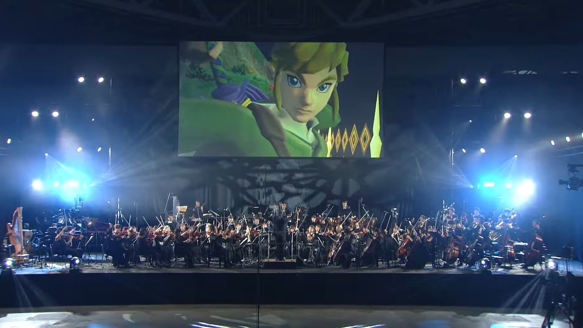 Link from Zelda on a big screen behind a stage with a full orchestra