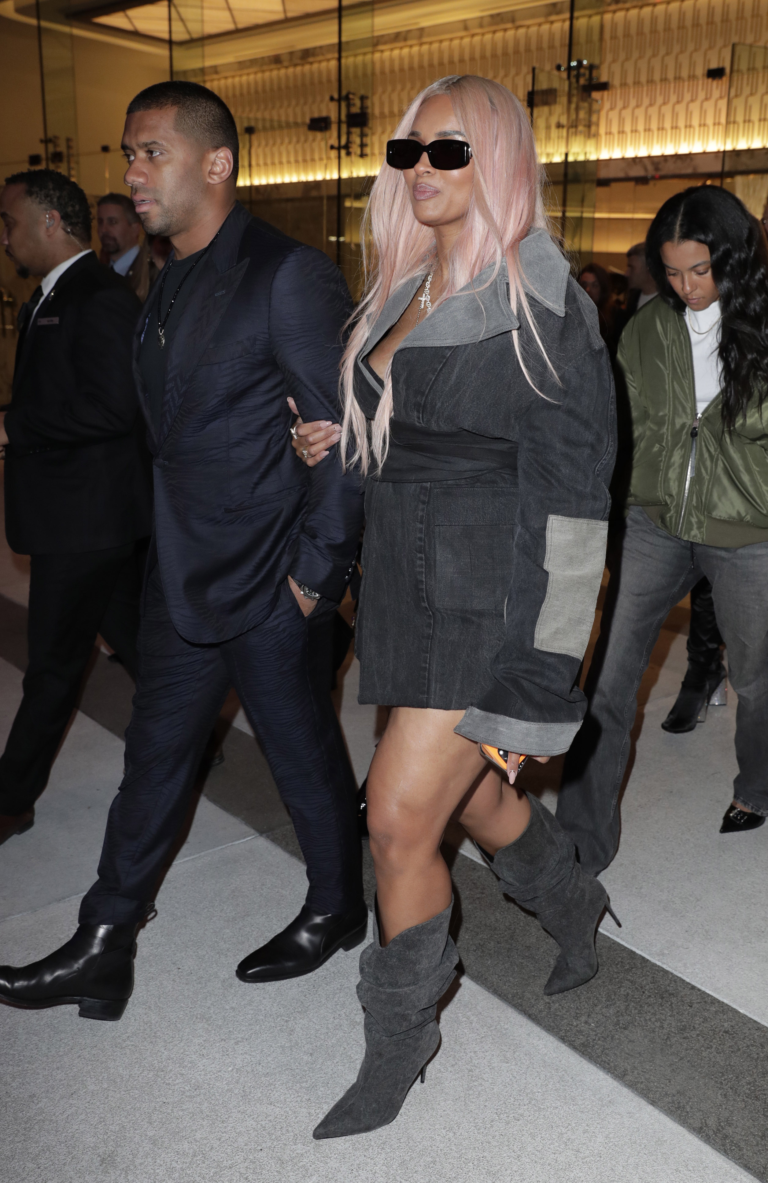 The pop star stunned in a pair of gray-heeled boots and a matching jacket with shades